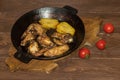 Chicken wings with potatoes fried in a pan