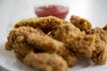 Chicken wings on a round white plate with ketchup, side view. Royalty Free Stock Photo