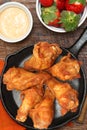 Chicken Wings in Skillet with Strawberries and Sauce