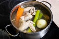 chicken wings soup is cooked in steel stewpot Royalty Free Stock Photo