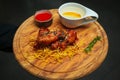 Chicken wings with tomato sauce on a wooden tray. Fried chicken wings, Thigh on wooden tray with ketchup and herbs.