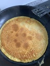 Chickpea pancake in the frying pan