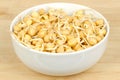 Chickpea sprouts, in a white bowl, on a bamboo board