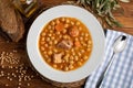 Chickpea stew dish potage - cocido madrileÃÂ±o. With beef, sausage chorizo, bacon, carrots and olive oil. Rustic appearance. Royalty Free Stock Photo