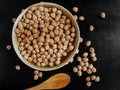 Chickpeas in a clay bowl, wooden spoon on Royalty Free Stock Photo