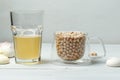 Chickpea grains in a glass Cup and aquafaba, the liquid obtained after decocting chickpeas or beans, is used in cooking instead of