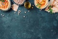 Chickpeas hummus, olive oil, raw chickpeas, smoked paprika, pita on dark background. Middle eastern, jewish cuisine or arabic