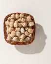 Chickpeas legume. Wicker basket with grains. Top view, hard light.