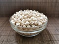 Chickpeas are nutritious foods. Healthy and vegetarian food. Chickpeas in a glass bowl on a brown mat.