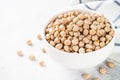 Chickpeas in white bowl at light kitchen table. Royalty Free Stock Photo