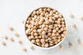 Chickpeas in white bowl at light kitchen table. Royalty Free Stock Photo