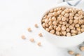 Chickpeas in white bowl at light kitchen table. Royalty Free Stock Photo