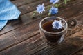 Chicory drink in transparent thermo glass cup with fresh flowers Royalty Free Stock Photo