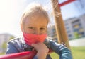 Chidren with a face mask on playground