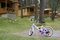 Chidren pink bicycle in wooden cabin mountain