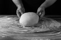 Chief baker preparing dough for bread in a bakery. Kitchen professional. Black and White Mood Effect