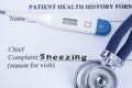 Chief complaint sneezing. Paper patient health history form, on which is written the complaint sneezing as the main reason for vis