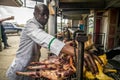 Chief cook preparing traditional east african grilled meat, Kenya