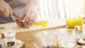 Chief cutting red bell peppers on a wooden board with a professional knife and a great skill. Royalty Free Stock Photo