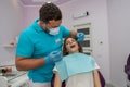 the chief dentist examines the treated healed teeth in a young woman. Royalty Free Stock Photo