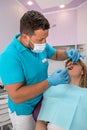 the chief dentist examines the treated healed teeth in a young woman. Royalty Free Stock Photo