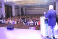 Speaker addressing a house full of conference audience