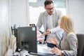 Chief and his female office worker arguing over documents in office. Royalty Free Stock Photo