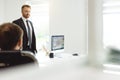 The chief manager and employees of the company interact and talk in the office. Meeting of the head with the staff to Royalty Free Stock Photo