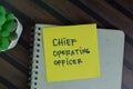 Chief Operating Officer write on sticky notes isolated on Wooden Table