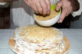 Chief sprinkling biscuit crumbs on holiday cake