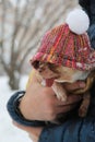 Chihuahua dog in a fashionable jacket in the arms of the owner in winter on a walk