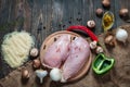Chiken breast On a cutting board with herbs different fruits and vegetables on rustic wooden background top view