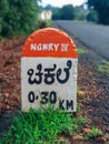 Milestone on a rural road at Chikhale village near Belgaum Karnataka Royalty Free Stock Photo