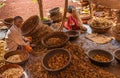 2 women collect waste of betel nuts in baskets, Chikkanayakanahalli, Karnataka, India