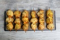 Chiken kebabs on wooden table