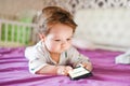 Child addiction to phones. radiation from the phone to the child. A little boy 0-1 years old with a smartphone in his