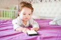 Child addiction to phones. radiation from the phone to the child. A little boy 0-1 years old with a smartphone in his hands looks