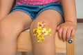 Child with adhesive bandage on knee Royalty Free Stock Photo
