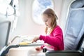 Child in airplane. Fly with family. Kids travel. Royalty Free Stock Photo