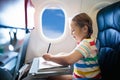 Child in airplane. Fly with family. Kids travel. Royalty Free Stock Photo