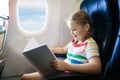 Child in airplane. Fly with family. Kids travel Royalty Free Stock Photo