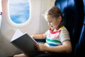 Child in airplane. Fly with family. Kids travel Royalty Free Stock Photo