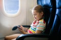 Child in airplane. Fly with family. Kids travel.pl Royalty Free Stock Photo