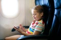 Child in airplane. Fly with family. Kids travel.pl Royalty Free Stock Photo