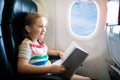 Child in airplane. Fly with family. Kids travel Royalty Free Stock Photo