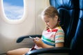 Child in airplane. Fly with family. Kids travel.pl Royalty Free Stock Photo