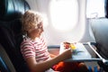 Child in airplane. Kids fly. Children flight meal Royalty Free Stock Photo