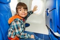 Child on airplane touch window with hand Royalty Free Stock Photo