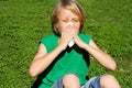 Child with allergy blowing nose