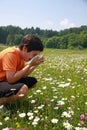 Child with an allergy to pollen while sneeze in the middle of th Royalty Free Stock Photo